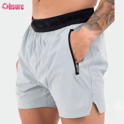 Logotipo personalizado na cintura Bolsos de poliéster Bainha dividida Pour Hommes Sports Active Shorts atléticos de ginástica para homens